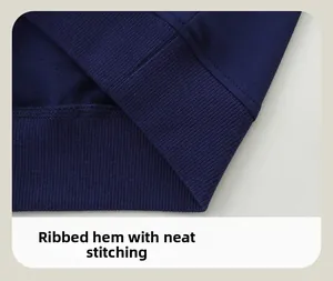 Detailed macro view of the ribbed hem and neat stitching on navy blue cotton sweatshirt
