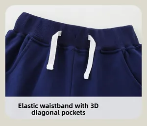 Close-up of boys navy blue jogger pants with elastic waistband and white drawstring ties