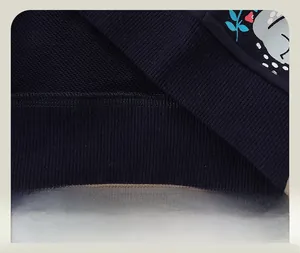Detailed view of navy blue knit hoodie with ribbed hem and high-quality stitching detail