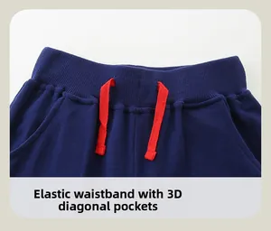 Detail of navy boy's joggers featuring elastic waistband and 3D slanted pockets