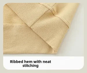 Close-up of ribbed hem and neat stitching on beige cotton kids sweatshirt