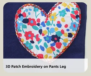 Detail of 3D heart-shaped floral patchwork embroidery on navy blue toddler trousers