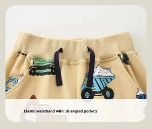 Detail of elastic waistband and pockets on kids trousers with vehicle prints