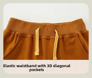 Detail of kids' cotton joggers featuring elastic waistband with drawstring and side pockets