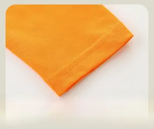 Close-up of bright orange long sleeve knitted cotton cuff with double-needle stitching