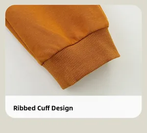 Detail of ribbed cuffed design on orange cotton blend fabric of kids tracksuit