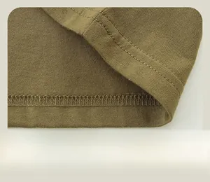 Detail of double-needle hem stitching and olive knit fabric on boys long sleeve shirt