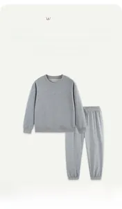 Detailed close-up of grey cotton kids sweatshirt and jogger set with ribbed cuffs