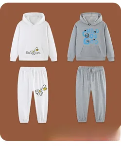 Detailed close-up of cotton hoodies with Bee and Child of God prints on a flat lay