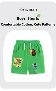 Detail of green boys' cotton shorts with cute animal patches and elastic drawstring waist