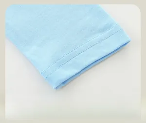 Detail of neatly stitched cuffs on light blue long sleeve dinosaur print children t-shirt