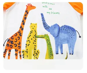 Detail view of cartoon animal prints and raglan sleeve stitching on orange boy's t-shirt
