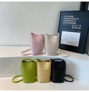 Detailed display of five colors of pebble leather crossbody phone bags on tiered display