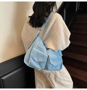 Détail du sac cabas en velours côtelé bleu clair avec poches et bandoulière réglable