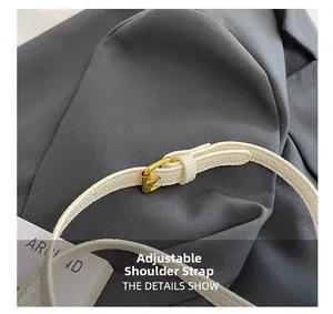 Close-up of white lychee texture adjustable shoulder strap with gold metal buckle