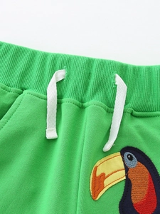 Kids green knit shorts with elastic waist, white drawstrings and toucan embroidery