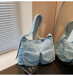 Détail du sac fourre-tout en velours côtelé bleu clair avec poches avant et boucles en argent