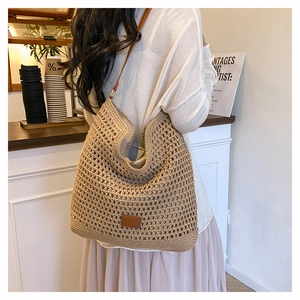 Macro detail of khaki woven mesh tote with brown leather strap and brand patch