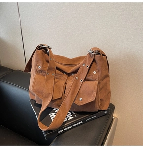 Détail d'un sac cabas marron en velours côtelé avec œillets métalliques et poches vintage