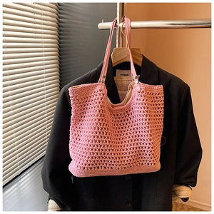 Detailed pink crochet tote bag with woven hollow mesh and slim leather shoulder straps