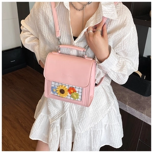 Detailed shot of pink PU leather mini backpack featuring a floral transparent window