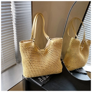 Detailed close-up of a woven tote bag with hollow out mesh and leather handles