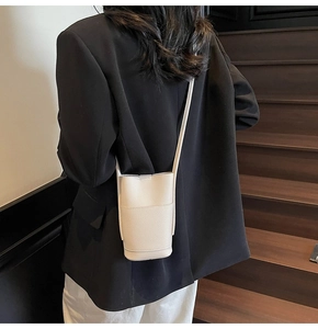 Chic small white crossbody phone bag shown on a model for casual lifestyle use