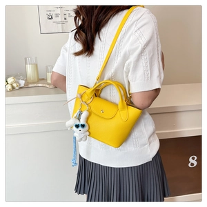 Mini yellow tote bag with pebble leather texture and cute white rabbit charm accessory
