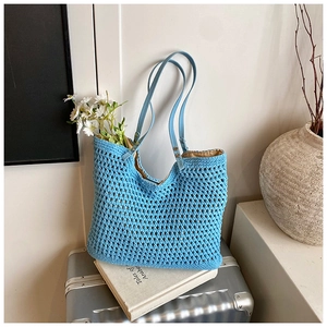 Detail of blue crochet tote bag showing woven texture and beige inner lining