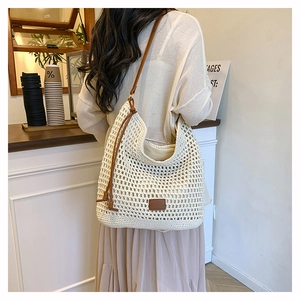Detail of hand-woven crochet hobo bag with brown leather straps and drawstring accents
