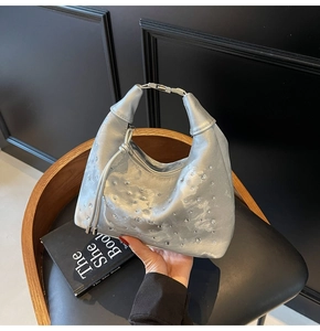 Close-up of the silver hobo bag featuring pleated metallic leather and sparkling rhinestones