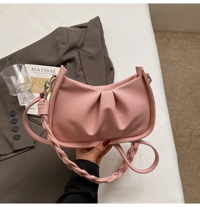 Detail of pink leather cloud bag with woven shoulder strap and gathered design