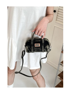Détails du sac Boston en denim délavé avec logo en métal et bandoulière réglable