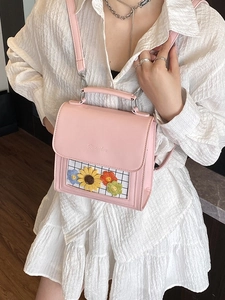 Pink leather mini backpack with sunflower window display for casual street style wear