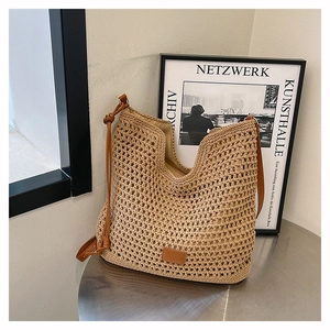 Detail of hand-woven crochet tote bag showing natural beige texture and leather drawstring strap