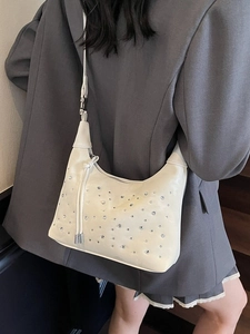 Chic off-white pleated crescent bag with scattered silver rhinestones and metal zipper
