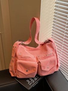 Sac cabas en velours côtelé rose avec boucles sur une chaise en cuir au soleil