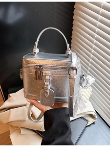 Minimalist silver bucket bag with metallic crinkle texture and pearl lace charm