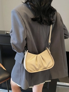 Minimalist beige dumpling shoulder bag in pleated litchi pattern PU leather for women