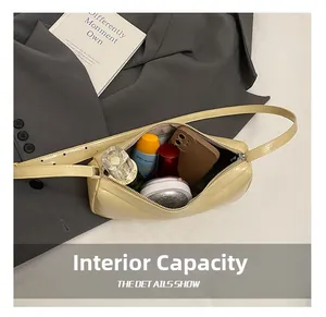 Internal capacity of beige baguette bag showing space for phone, perfume and cosmetics