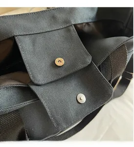 Detail of high-quality magnetic metal buckles and durable canvas texture on a tote bag