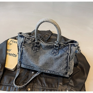 Détails du sac cabas en denim bleu vintage avec texture délavée et surpiqûres