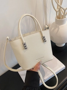 Chic off-white leather bucket bag with silver bead accents and crossbody strap