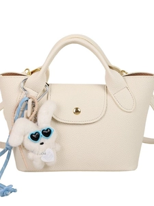 Mini cream tote bag with pebble leather, gold buckle, and plush rabbit charm