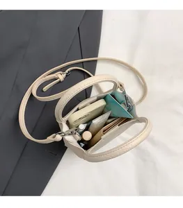 Interior view of beige lychee leather bucket bag showing storage space for phone and wallet