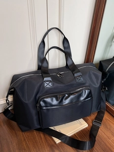 Black high-capacity travel bag with adjustable strap and durable nylon fabric in 45-degree view