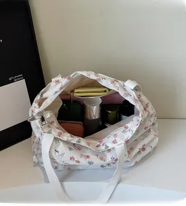 Interior view of floral canvas tote bag showing large capacity with personal items