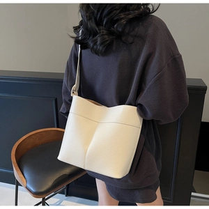 Fashionable white litchi pattern leather bucket bag shown as worn on shoulder