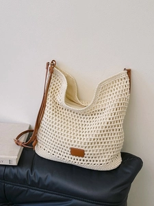 Creamy white woven hobo tote bag with brown leather straps for summer beach vacations