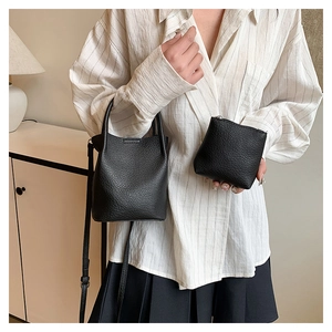 Close-up of black lychee grain bucket bag set with matching zippered coin purse and strap